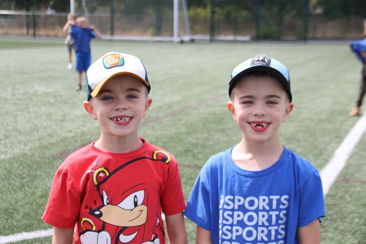 Two children smiling in uSports kit