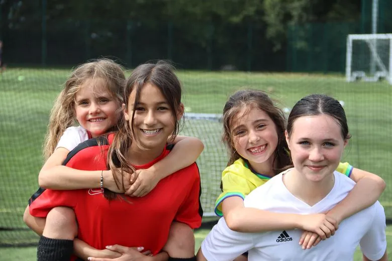 Girls playing football at the uSports Woodley girls camp