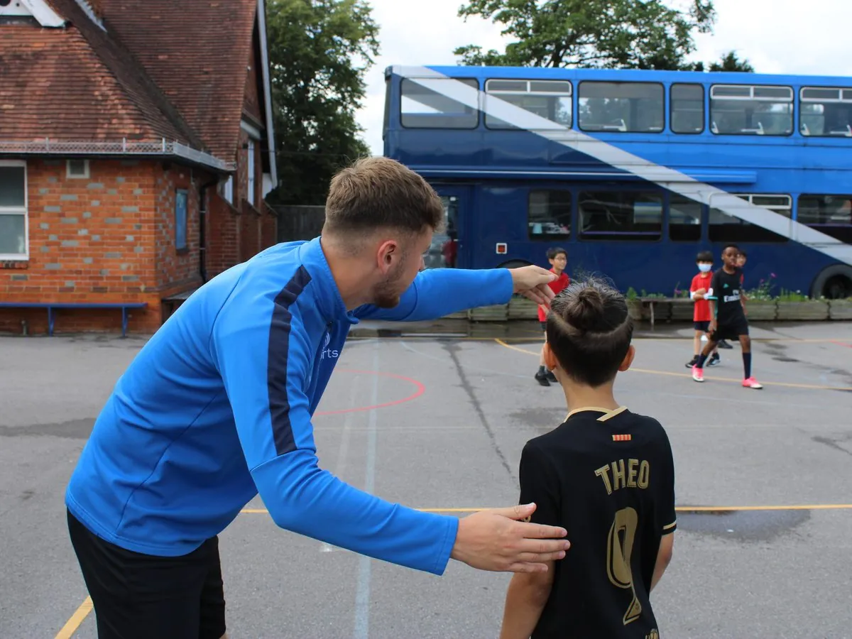 uSports coach guiding a pupil during a club session