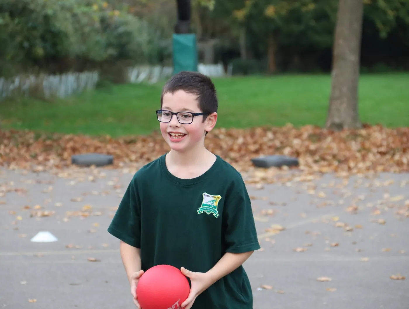 Pupil holding a dodgeball at a uSports extra curricular club