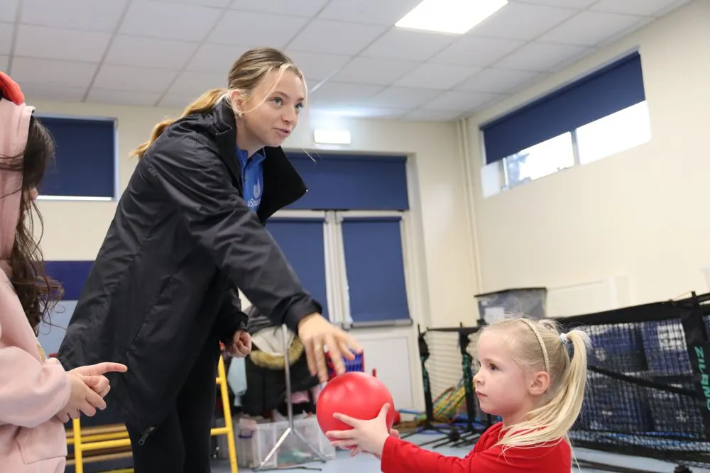 uSports coach supervising a child at a holiday camp