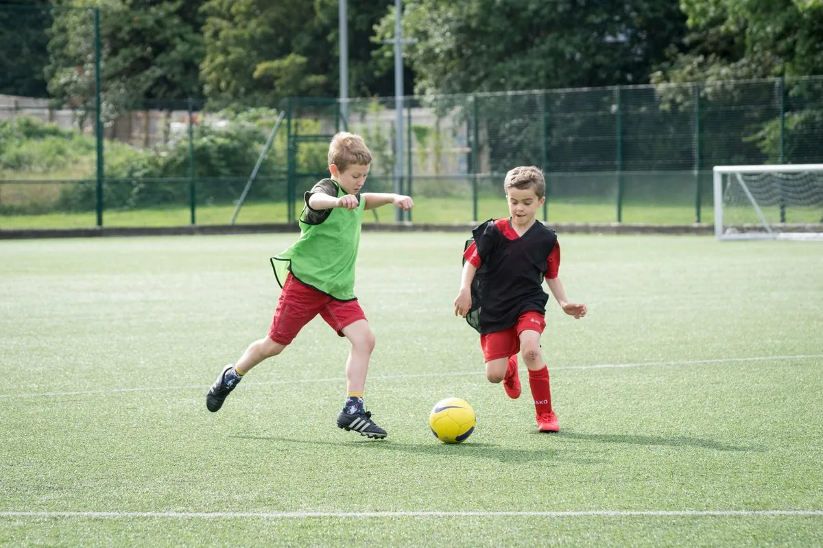 Two young players competing for the ball at a uSports session