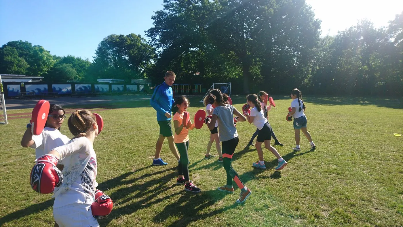 Children taking part in a uSports boxing pads workshop