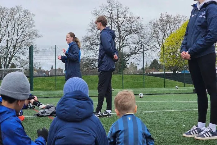 uSports coaches briefing children at the start of a session