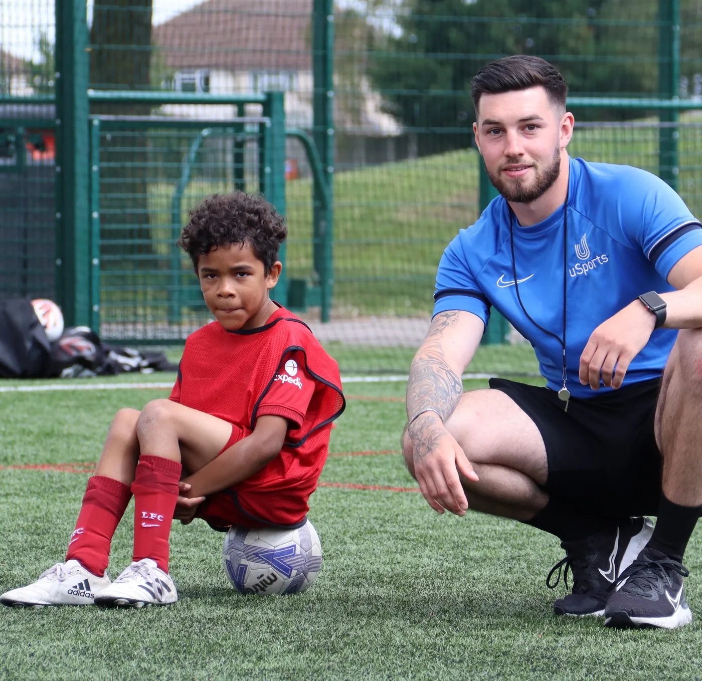A uSports coach working one to one with a child